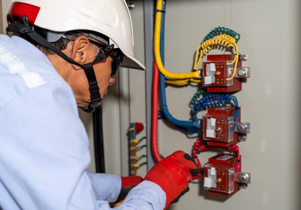 Latin electrical engineer performs maintenance on an industrial circuit