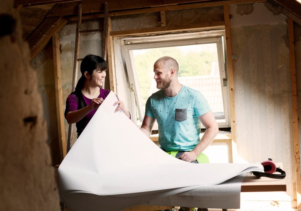 Two people reviewing plans during a home renovation